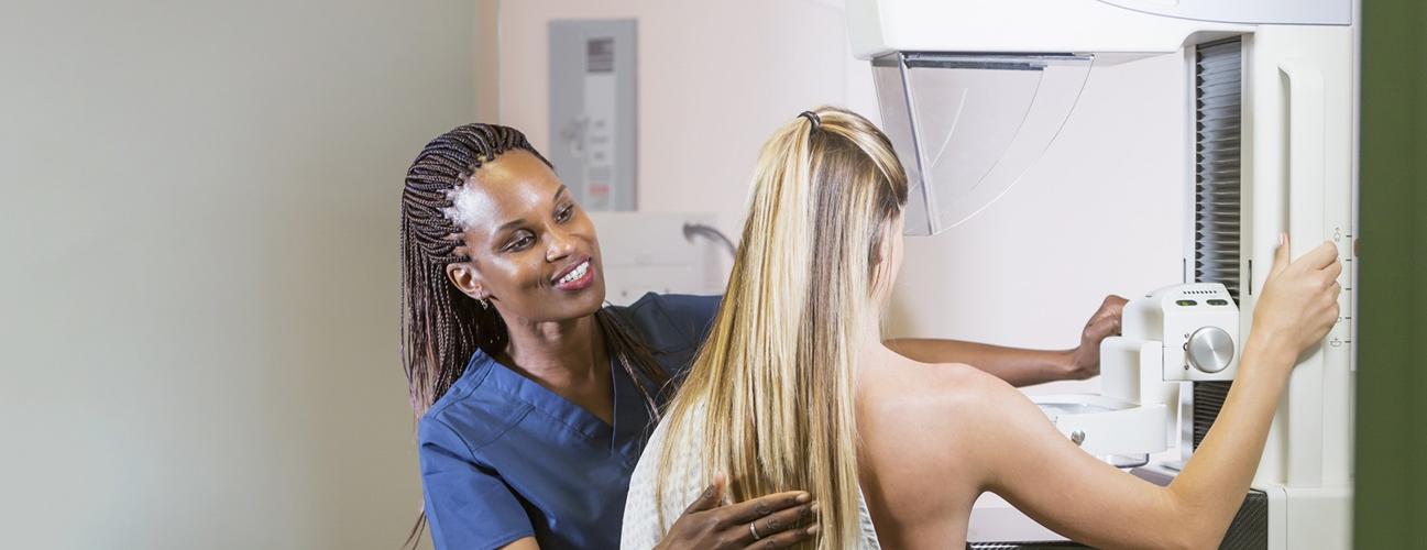 A woman receives a mammogram.